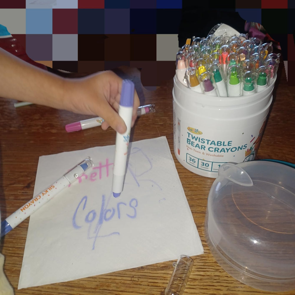 Colourful artwork beside the crayon set