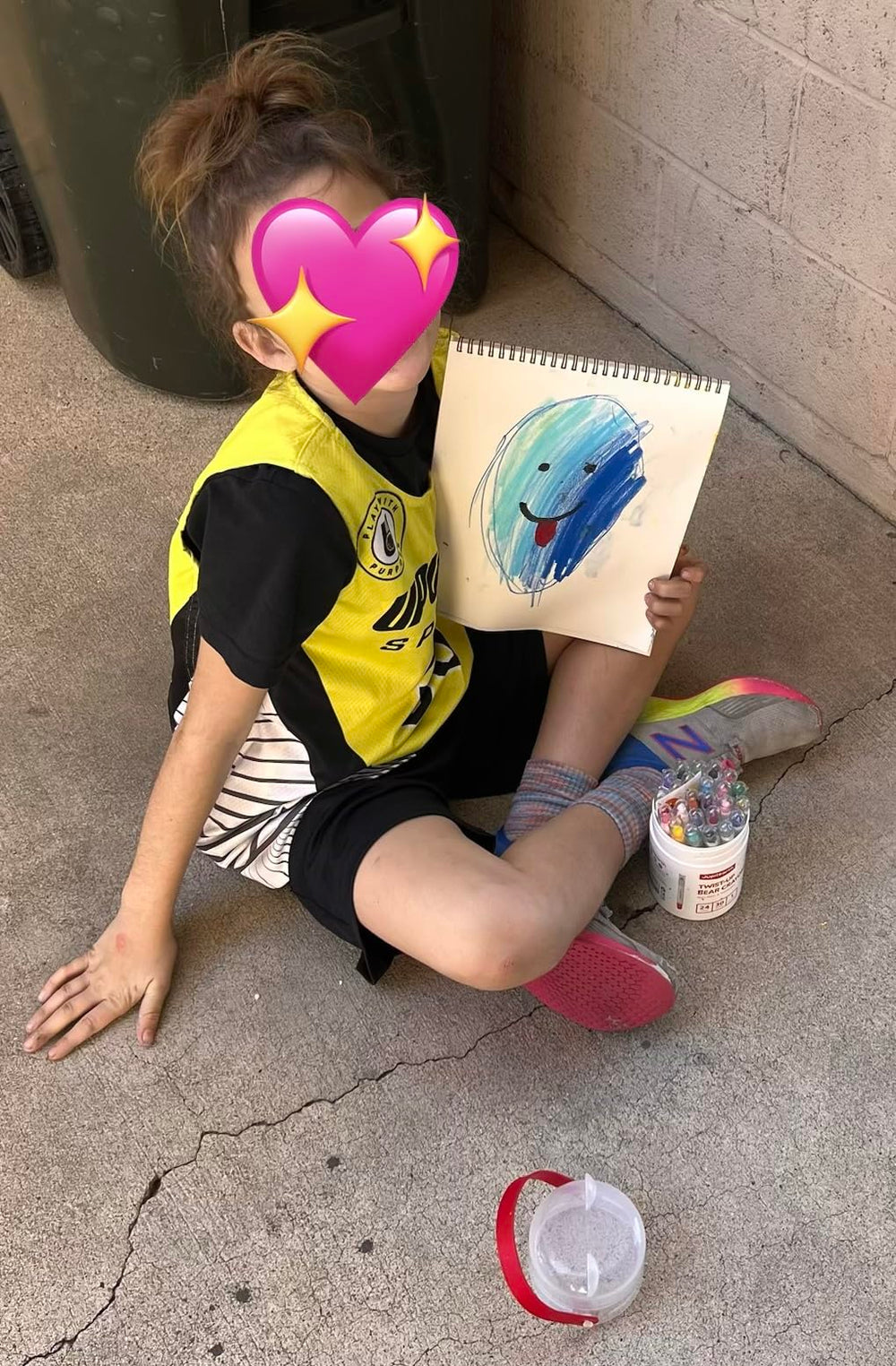 Child creating colourful artwork